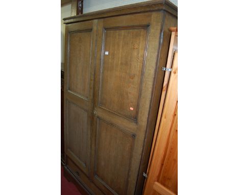 A joined oak double door wardrobe having single long lower drawer, width 110cm