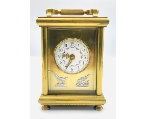 French early 20th century brass cased carriage clock The plain moulded case with floral decorated enamelled dial, the brass p