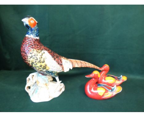 Pair of Poole pottery ducks, and Italian pottery model of pheasant