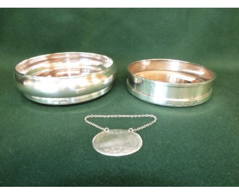 Two hallmarked silver wine coasters and silver port label