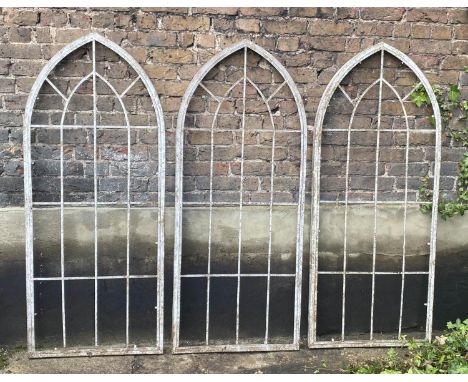 ARCHITECTURAL GARDEN FRAMES, a set of three, 160cm high, 67cm wide, Gothic style, aged metal. (3) 
