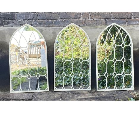 ARCHITECTURAL GARDEN WALL MIRRORS, a set of three, aged white painted frames, 76cm x 42cm. (3) 