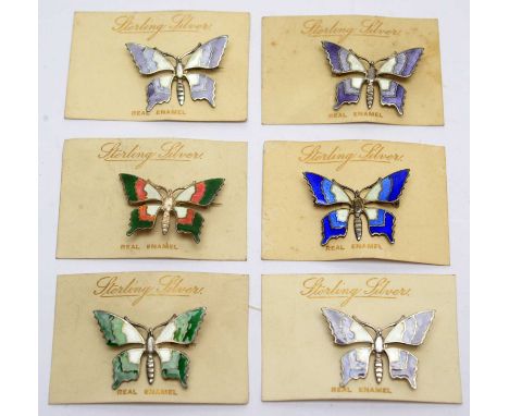 Six silver and enamel butterfly pattern brooches, backed on original retail cards, inscribed 'Sterling Silver Real Enamel'.