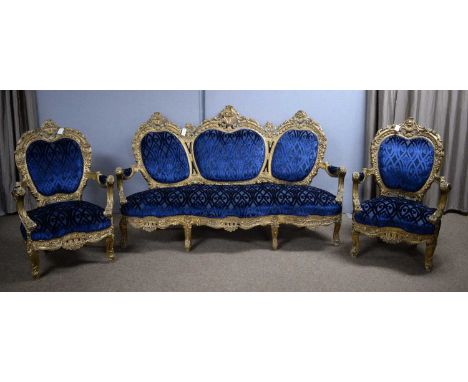 An ornate Italian style three-piece salon suite, comprising: a sofa with triple padded back within carved leaf, flower and 'C