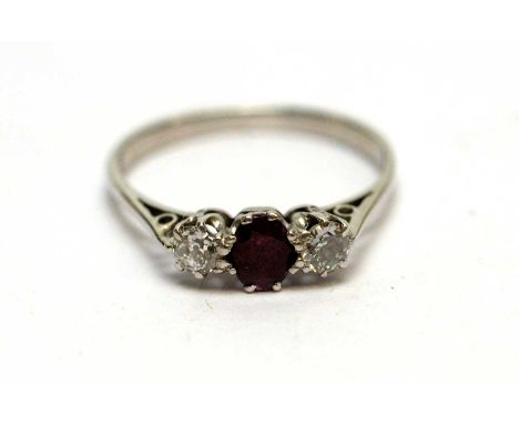 A diamond and ruby three-stone ring, on an 18ct white gold shank, ring size L.