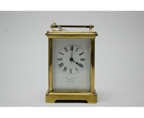 A French brass-cased carriage clock, retailed by Snow &amp; Ashworth, Harrogate, 15cms high.