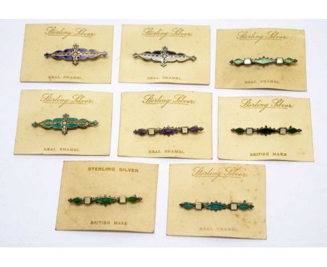 Eight silver and enamel brooches, backed on original retail cards, inscribed 'Sterling Silver Real Enamel'.