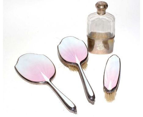 A silver-backed and polychrome enamel hand mirror, matching hand brush and clothes brush, Birmingham 1937; together with a cu