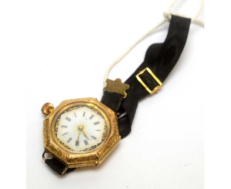 An 18ct yellow gold cased cocktail watch, with white and red enamel roman dial, floral engraved case, with black ribbon strap