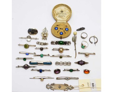 A selection of silver and other brooches, including; a rock crystal brooch; various green stones; a silver and blue enamel se