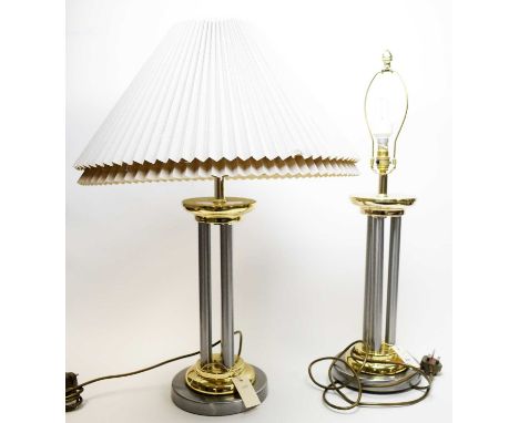 A pair of contemporary gilt and white metal table lamps, with triple pillar supports, each with shade.