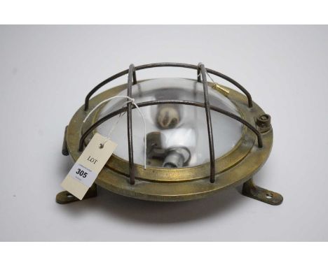 A maritime brass cased round ships wall light, 26cms diameter. 