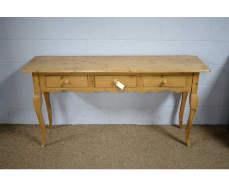 A French-style pine side/hall table, 20th Century, the rectangular top above three short drawers with turned knob handles, ra