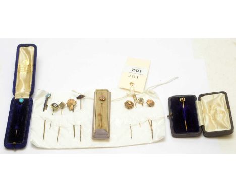 A collection of tie pins, many on gold sticks, including: a seed pearl set pin; a turquoise set pin; and others. 