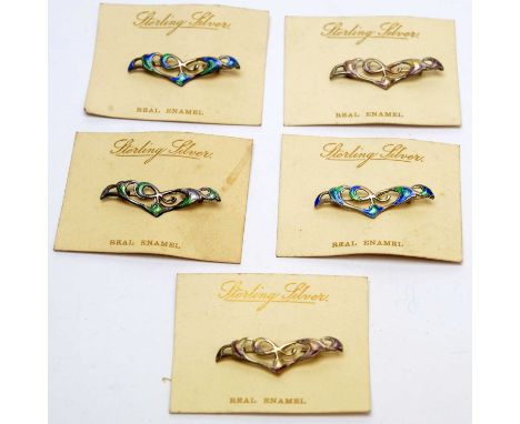 Five silver and enamel Arts and Crafts pattern brooches, backed on original retail cards, inscribed 'Sterling Silver Real Ena