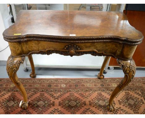 A Georgian-style burr walnut serpentine fronted card table, the folding swivel top with baize-lined writing surface and count