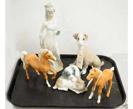 A selection of decorative ceramic figures, comprising: Lladro figure of a dog, 19cms high; together with a Nao figure group o