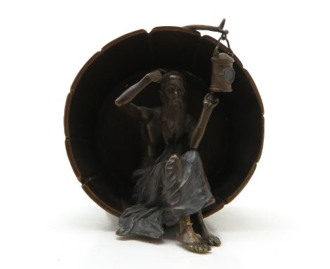 Depicting man sitting inside barrel with light, 11 cm. tall.