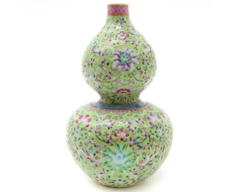 Light green background with famille rose enamels, marked with double ring and 6 characters on the bottom, 22 cm. tall.