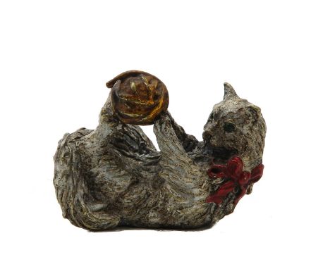 Depicting cat playing with yard, 5 cm. tall.