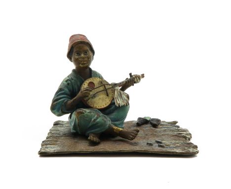 Depicting boy playing musical instrument, 7 cm. tall.