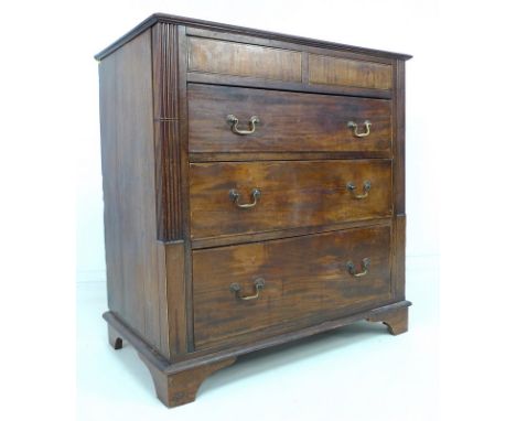 A George III mahogany and inlaid chest of two short over three long drawers, with line inlaid decoration, reeded and carved p