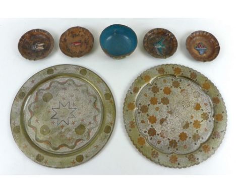 A set of four copper and enamelled dishes, with naturally moulded rims and black enamelled bases, two decorated with fish, on