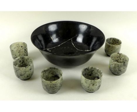 A set of six jade rice wine cups, grey with black specks, each 5 by 5cm, together with a dark mottled bowl, a/f cracked and r