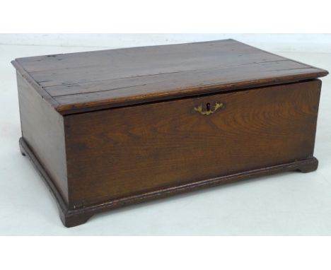 A small 18th century oak box, with lift lid and brass escutcheon, small bracket feet to moulded lower edge, 47 by 31 by 18.5c