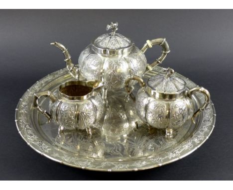 A Chinese Export four piece silver tea service including tray, circa 1900, each of lobed melon form with handles and tea pot 