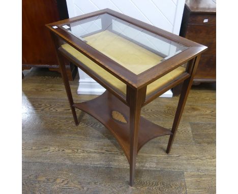 An Edwardian inlaid Bijouterie Table, of rectangular form, with hinged glazed lid, above a shelf inlaid to centre with a shel