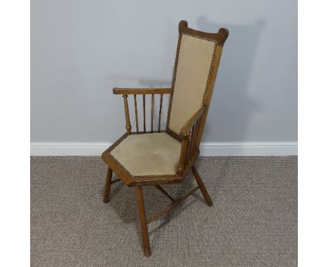 An Arts &amp; Crafts oak framed hexagonal Chair, with tall comb back and arms on spindle supports, raised on H stretcher, W 6