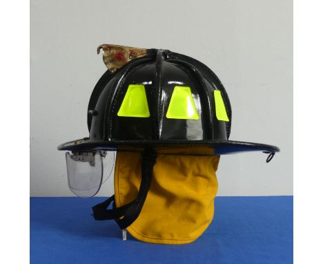 An American Cairns &amp; Brother embossed leather Fire Helmet, black, circa 1992, for New York Fire Department, with visor, i