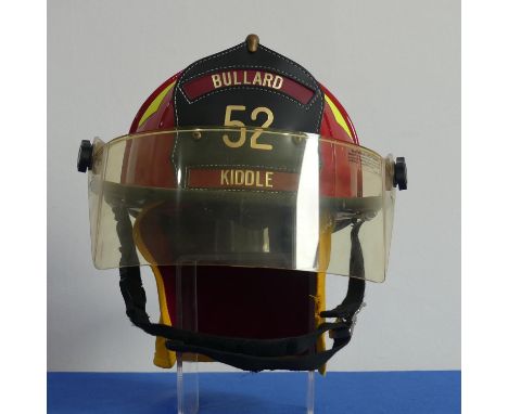 An American Bullard Firedome Firefighter's Helmet, red and yellow, with visor, the leather badge inscribed ?Bullard 52 Kiddle