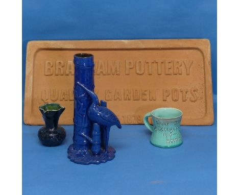 A vintage Brannam Pottery terracotta Advertising Plaque, W 51cm x H 25.5cm, together with three pieces of Brannam, to include