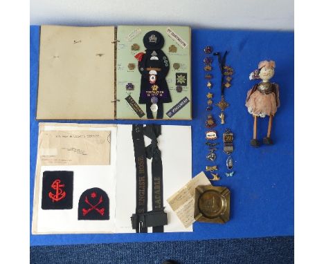 A collectors lot including a mid 20thC Girl Guide scrap book, badges, ribbons etc., together with an antique wood 'peg' doll,