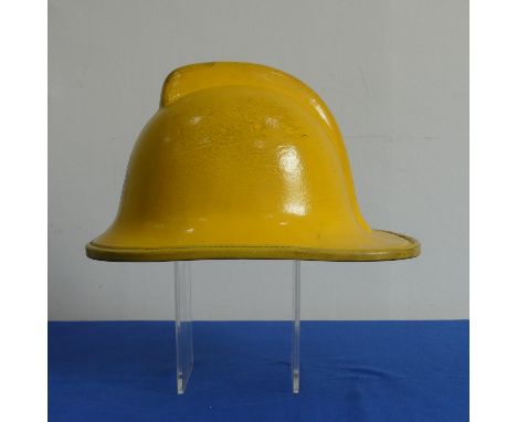 A yellow cork Fire Helmet, circa 1993, with leather lining and Northamptonshire transfer badge, together with a yellow fiberg