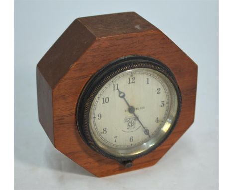 A 1940s Smiths aircraft/motor car clock, H-20929, with silvered dial, 9cm diameter, set in octagonal oak block