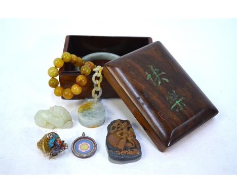 Six small Asian works of art in a wood box, comprising: an agate pendant or applique of a crane beside pine, 5 cm high; a gre