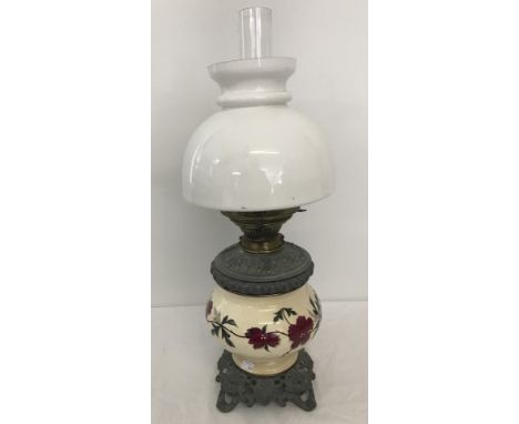 A vintage Hinks & sons oil lamp with ceramic bowl with red flower painted decoration. Complete with milk glass shade and chim