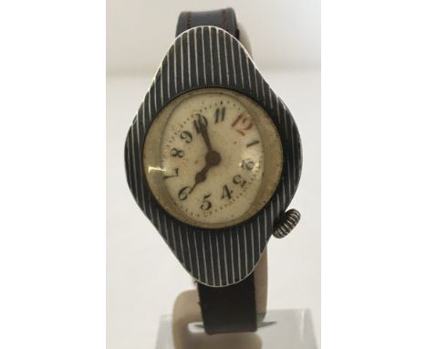 An early Niello automobile racing wristwatch with original period leather strap and buckle. Porcelain dial and hands all orig