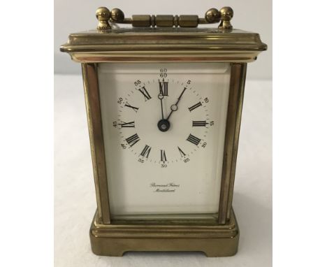 A French 1920's Bernard Freres, Montbeliard 8 day polished brass carriage clock. With bevel edged glass panels and drop down 