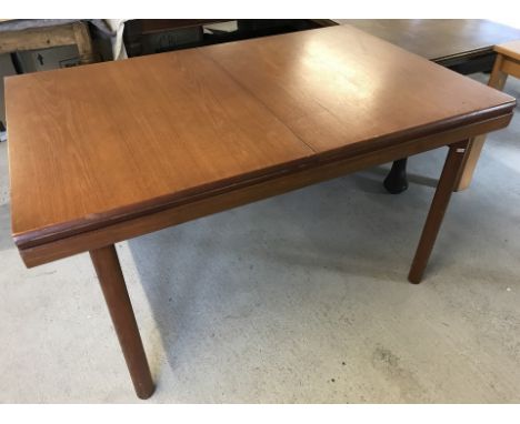 A vintage teak drawer leaf dining table with central leaf.  Approx. 137cm wide unextended x 73cm tall.