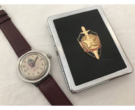 A vintage Russian Military KGB wristwatch together with cigarette case with built in lighter. Watch by Vostock with date cale