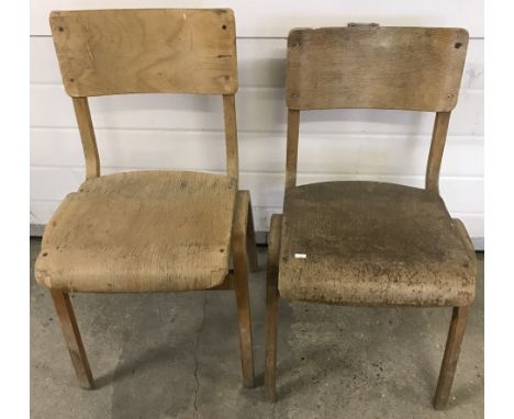 A pair of vintage light wood school chairs.  