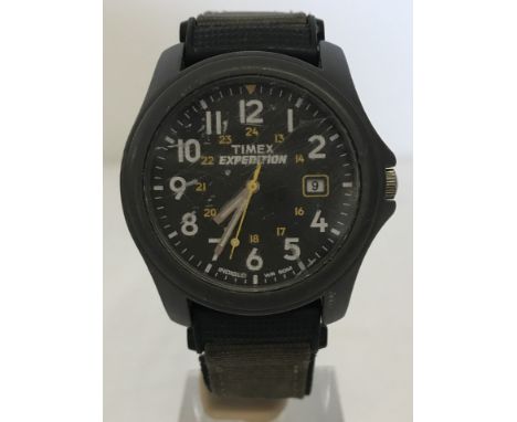 An Indiglo Timex Expedition watch in grey plastic casing. On original khaki and black fabric strap. 