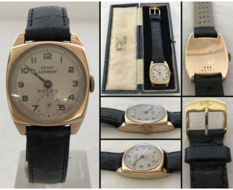 A vintage 9ct gold cased Rolex watch with a subsidiary second hand on a black leather strap. Retailers name on face and in or