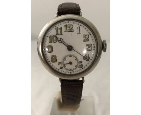 A hallmarked silver cased WWI trench watch on brown leather strap. Hallmarked inside London 1914, white enamel dial, blue ste