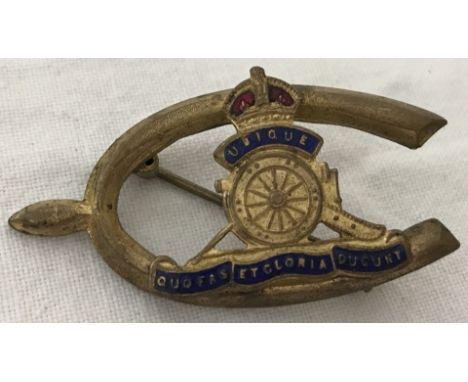 A vintage Royal Artillery gold tone & enamel sweetheart brooch. The Royal Artillery badge set inside a riding spur. 