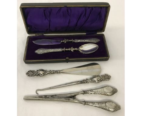 A collection of silver handles items. Comprising glove stretchers, shoe horn, button hook and a boxed preserve set. 